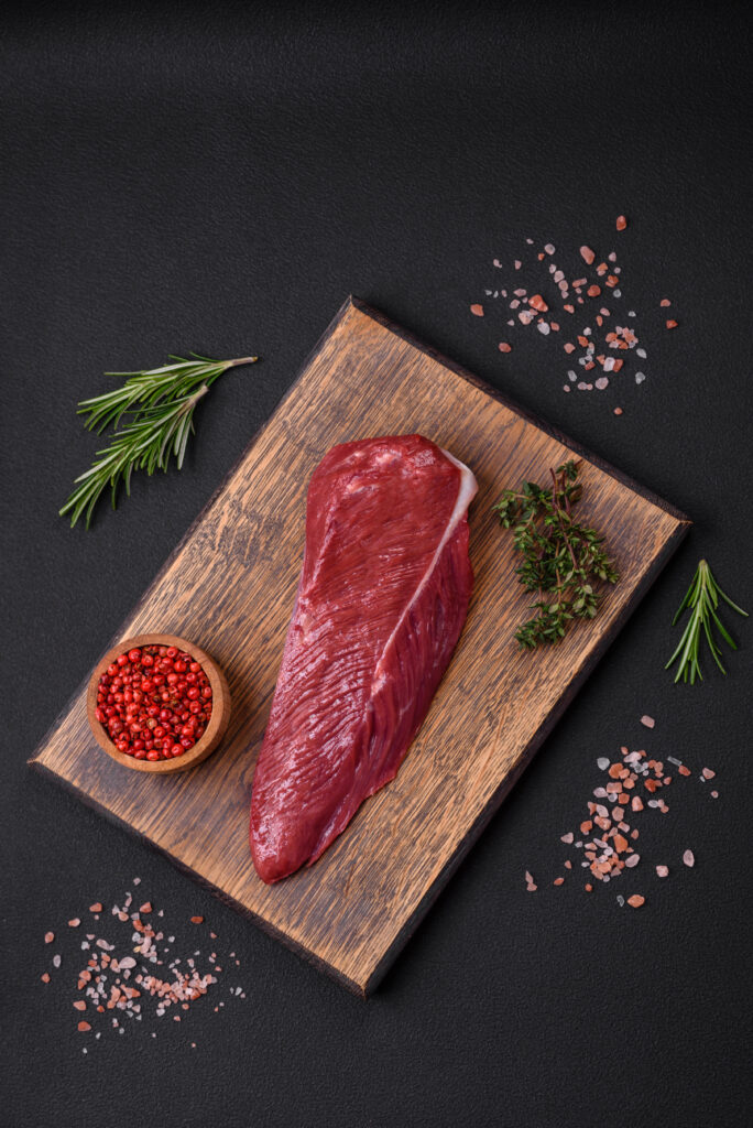 beautiful fresh piece of raw beef on a wooden cutting board beautiful fresh piece of raw beef on a wooden cutting board